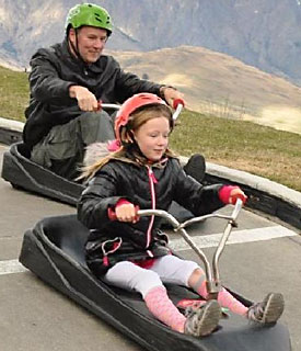 Your tour leader and his daughter, five years back, racing down a luge in New Zealand.